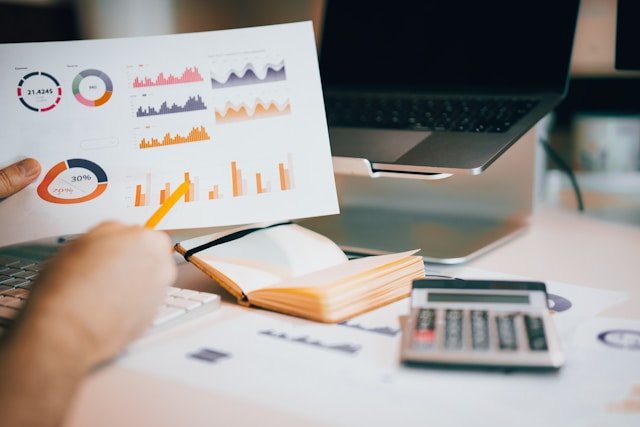 Investor analyzing charts desk